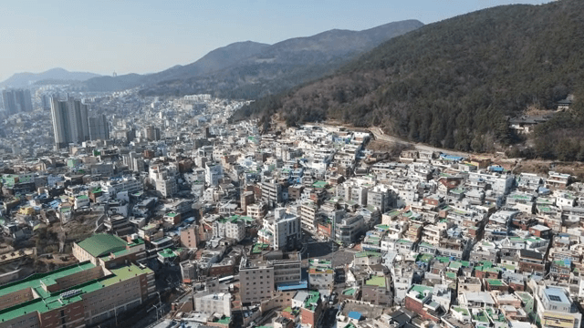 Colorful hillside village with mountains
