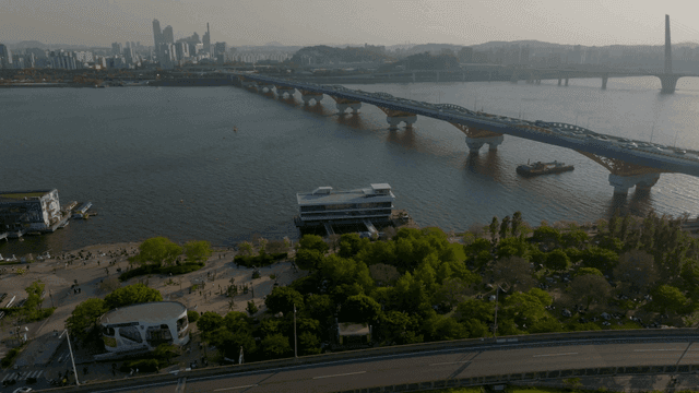 A bridge over a river with a city skyline