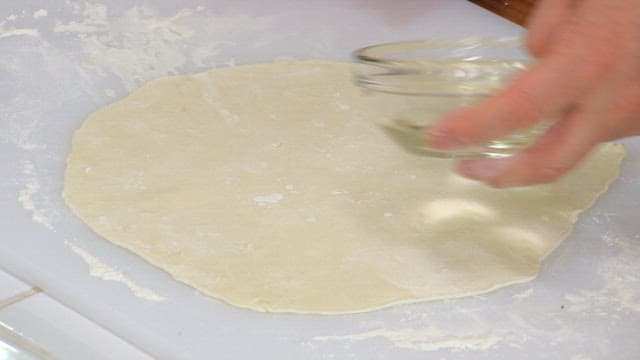 Pouring water into flour dough