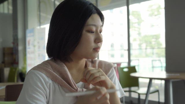 Woman sitting in a cafe and reading a book