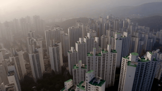 Densely packed apartments under a cloudy sky