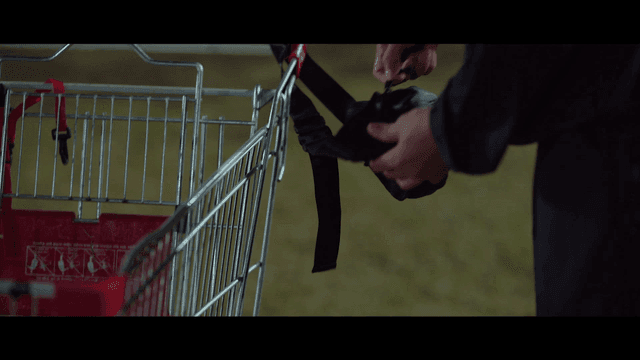 Person taking envelope out of bag in shopping cart