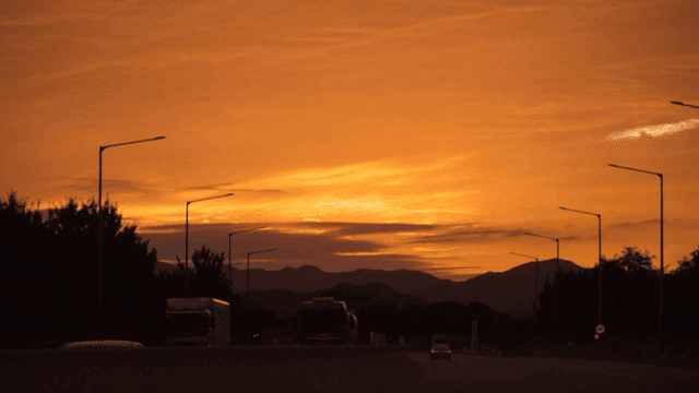 Highway at sunset with mountains