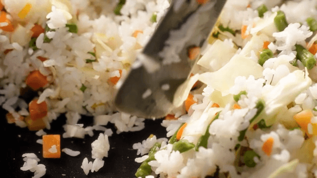 Colorful vegetable fried rice being cooked