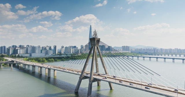 Modern bridge over a river with cityscape