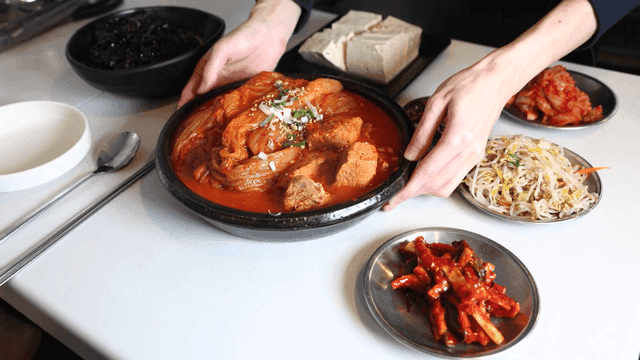 Table set with kimchi stew and side dishes.