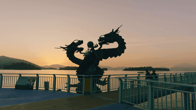 Dragon statue on a bridge at sunset