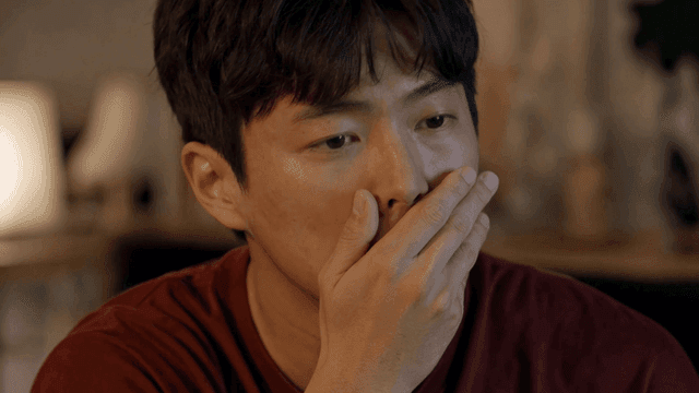 Nervous man covering his mouth with his hand