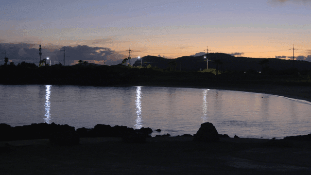 Quiet beach and distant hills in evening