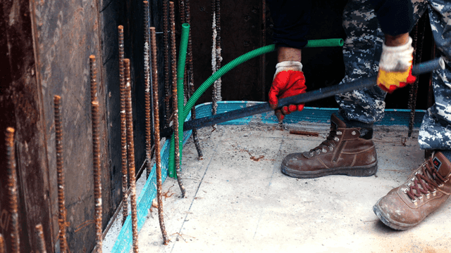 Worker in camouflage pants at a construction site