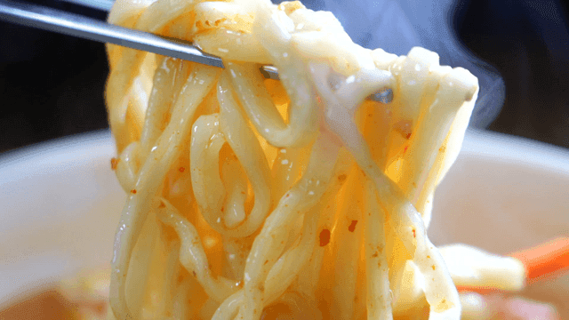 Chopsticks lifting spicy seafood kalguksu