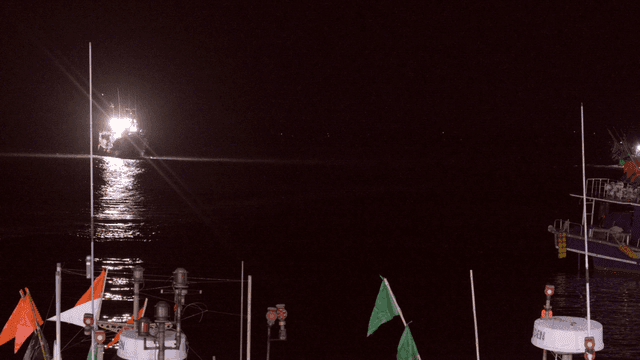 Fishing boats at night with bright lights