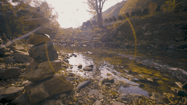 Serene stream with stacked stones