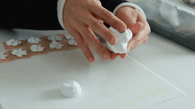 Hands touching white clay