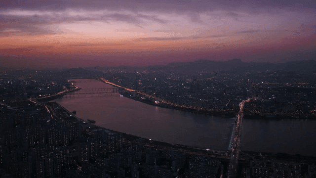 Cityscape with view of river at sunset.