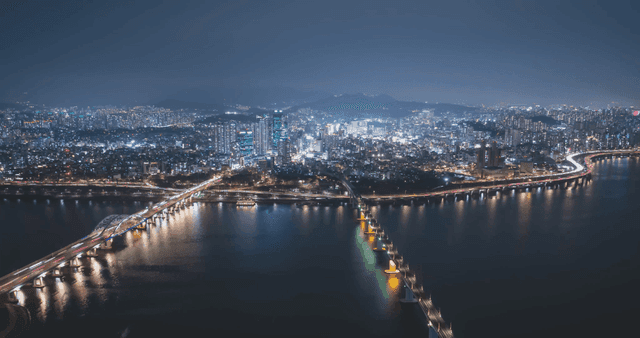 Vibrant city landscape with brightly lit bridge