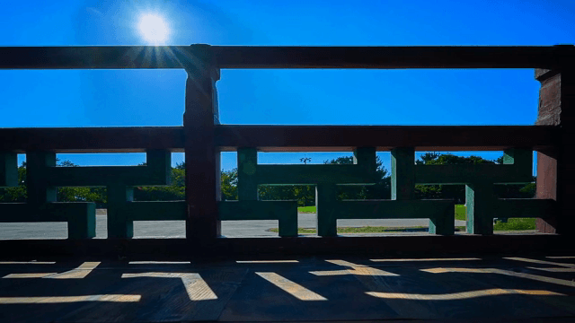 Traditional wooden railing under bright sun