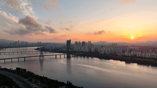 City skyline with a river at sunset