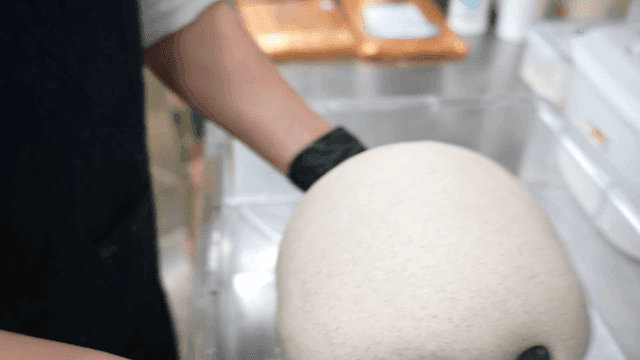 Baker who handles large dough in kitchen