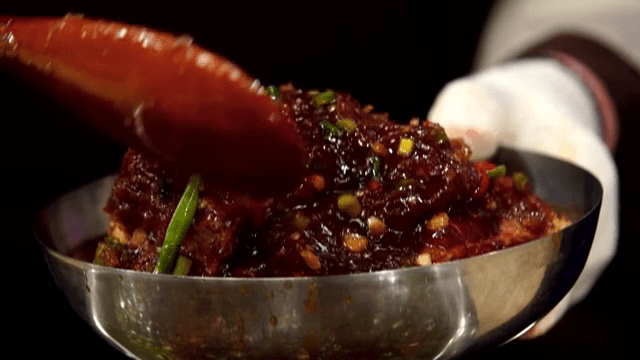 Marinated galbi in a metal bowl