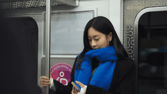 Woman using smartphone on subway
