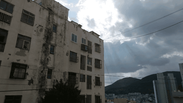 Old apartment under cloudy sky