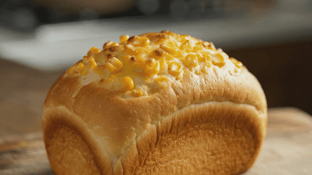 Freshly baked corn bread on wooden cutting board