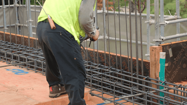 Construction worker handling rebar