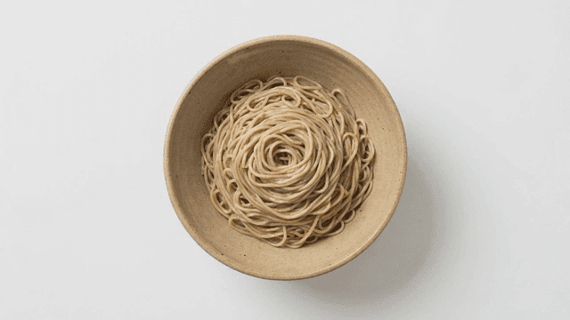 Bowl of buckwheat noodles placed on white background