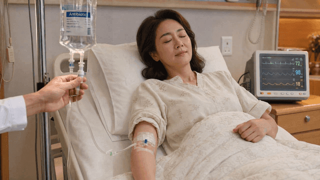 Woman resting in hospital bed after receiving antibiotic IV drip