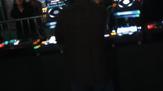 DJ Performing Passionately Under Flashing Lights