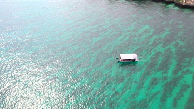 Bangka floating on a clear emerald sea