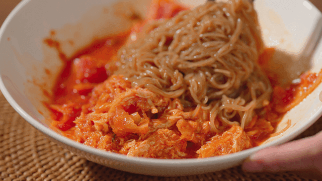 Spicy mixed noodles in a white bowl