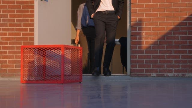 Two people walking on a rooftop