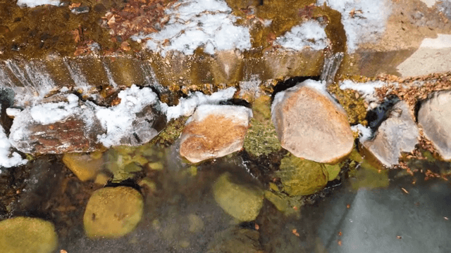 Frozen river with rocks and snow