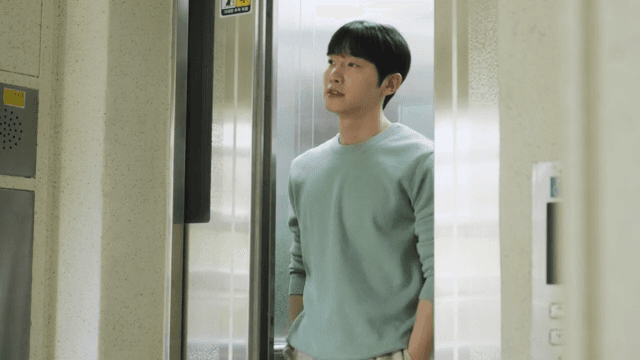 아파트 건물의 엘리베이터가 열리고 내리는 남자