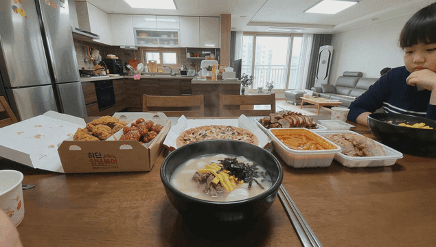 Variety of delivery foods and tteokguk on table
