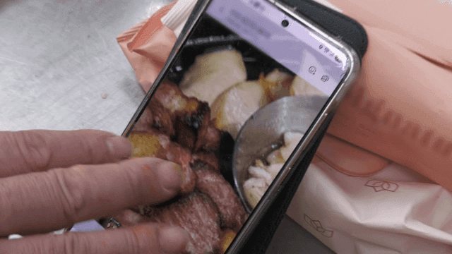 Person checking food photos on their phone