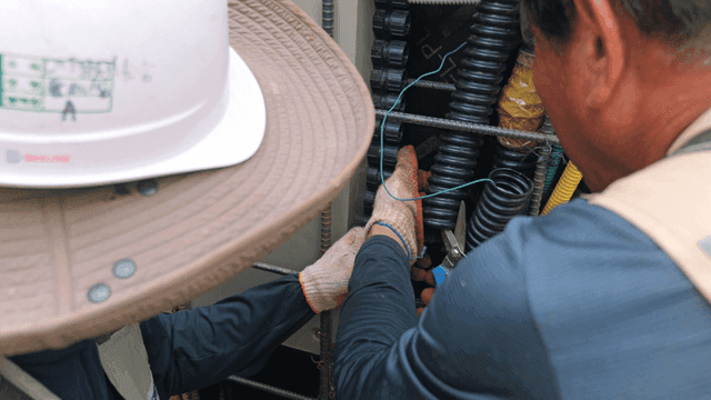 Workers handling cables at a construction site