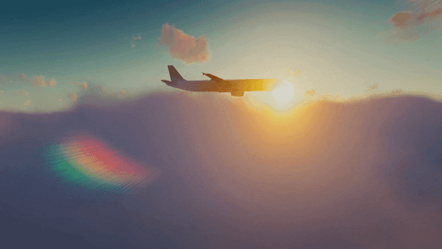 일출 시 구름 위를 나는 비행기