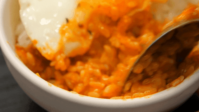 Rice mixed with kimchi stew broth and soft-boiled fried egg
