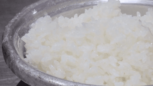 Steamed rice being stirred in a pot