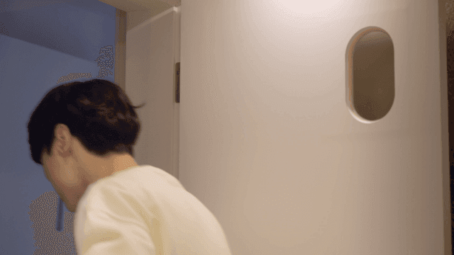 Couple playfully brushing teeth together in bathroom
