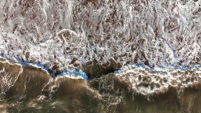 Waves crashing on a sandy beach