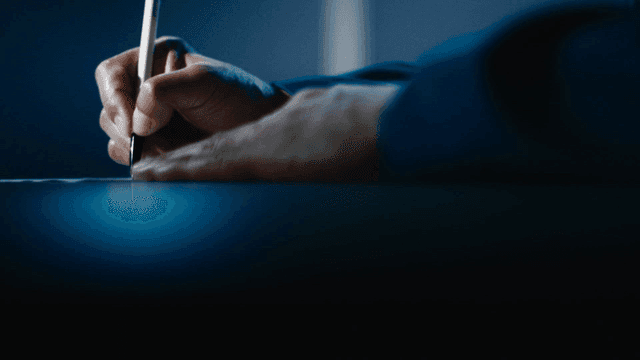 Person writing with a pen on paper