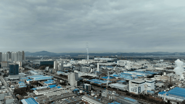 Industrial city landscape spread out beneath cloudy sky