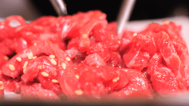Fresh raw beef sprinkled with sesame seeds