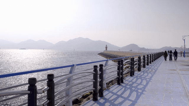 People walking along a seaside promenade