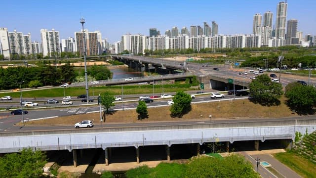 Urban park between busy roads and tall buildings