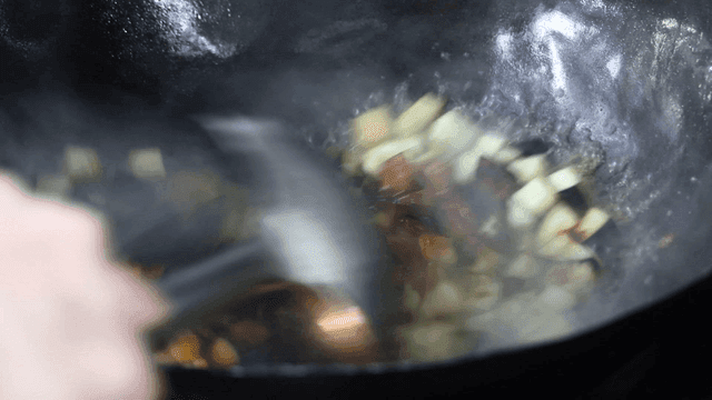 Eggplant stir-fried with sauce in hot wok